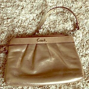 Gold metallic Coach wristlet